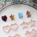 Holiday origami polymer clay cutter set with heart star snowflake and gingerbread shapes