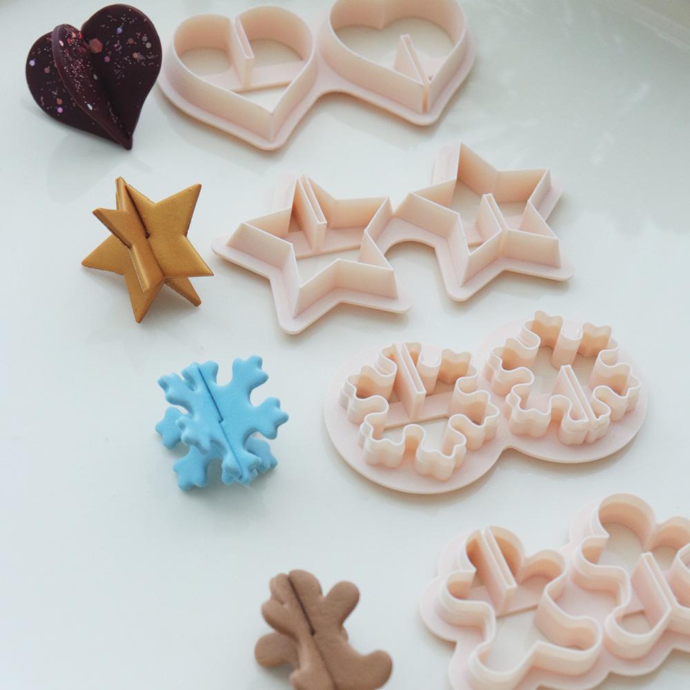 Holiday origami polymer clay cutter set with heart star snowflake and gingerbread shapes