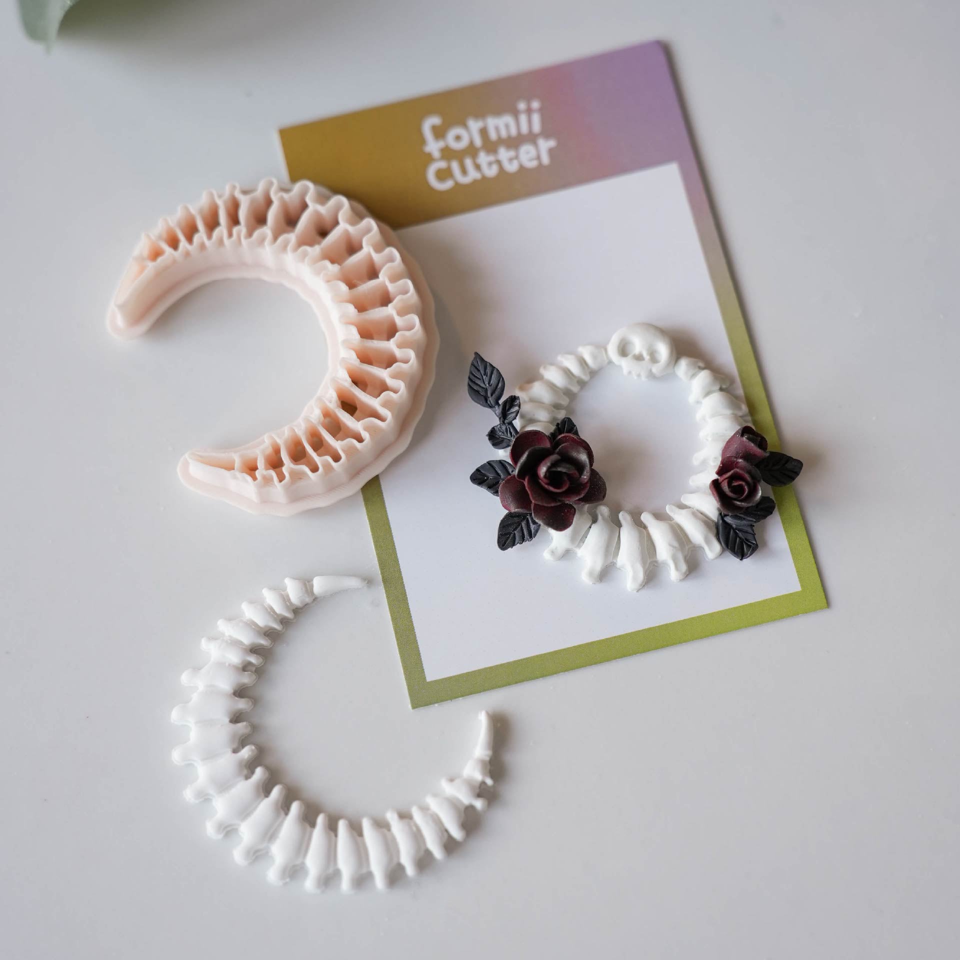 Crescent moon bone cutter and finished skeletal clay crescent