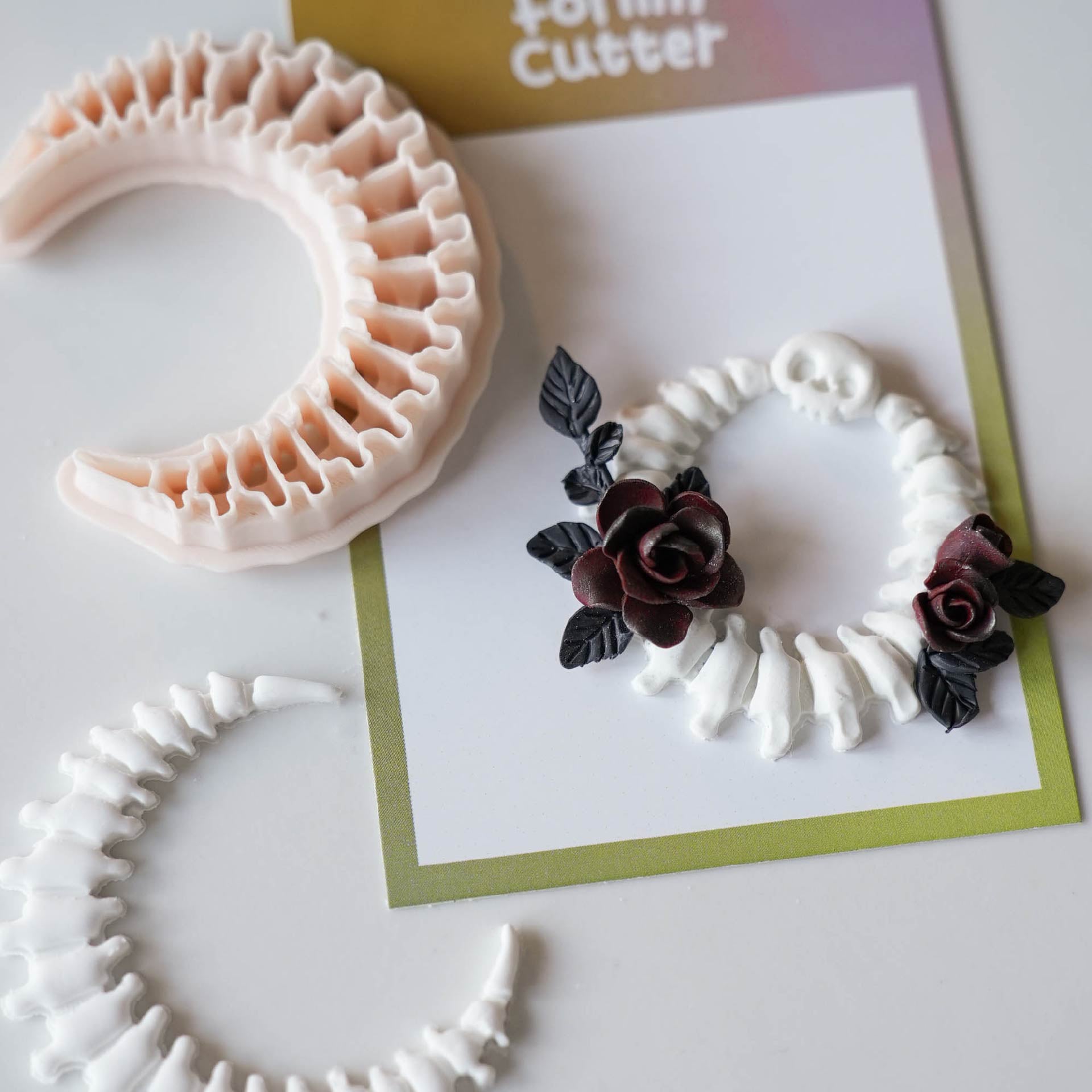Crescent moon spine cutter with finished gothic clay jewelry