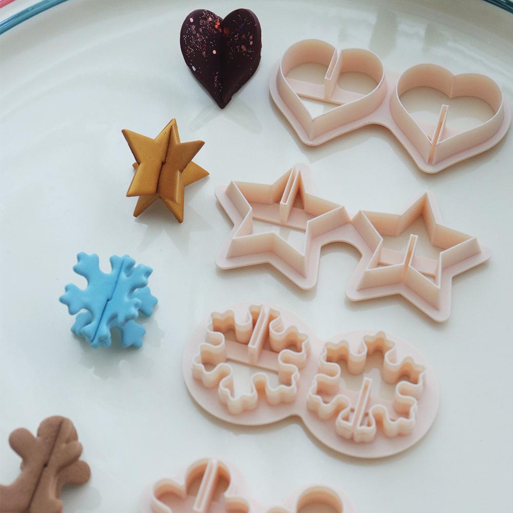Holiday origami polymer clay cutter set with heart star snowflake and gingerbread shapes