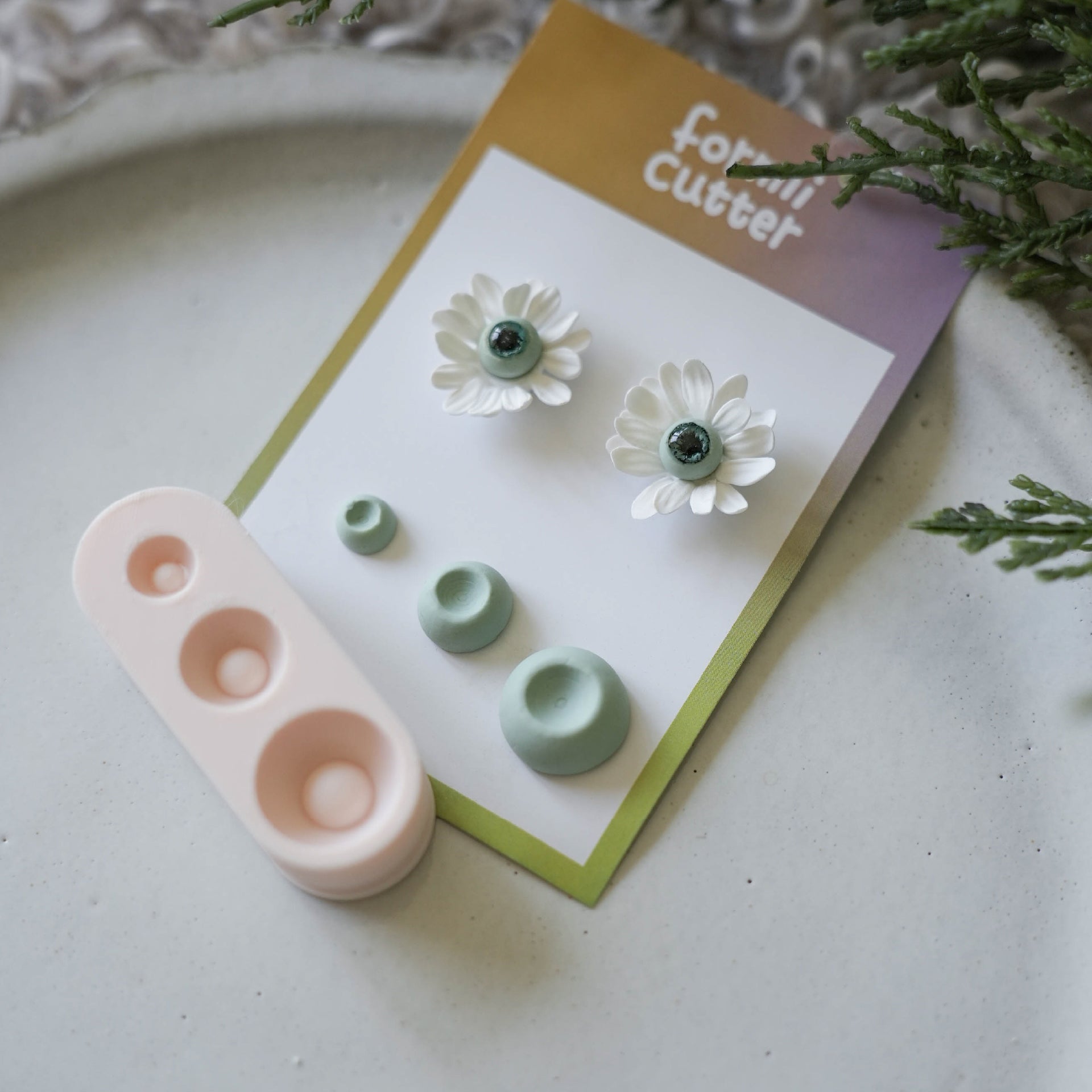 Three-size polymer clay flower center forming tool with finished floral pieces