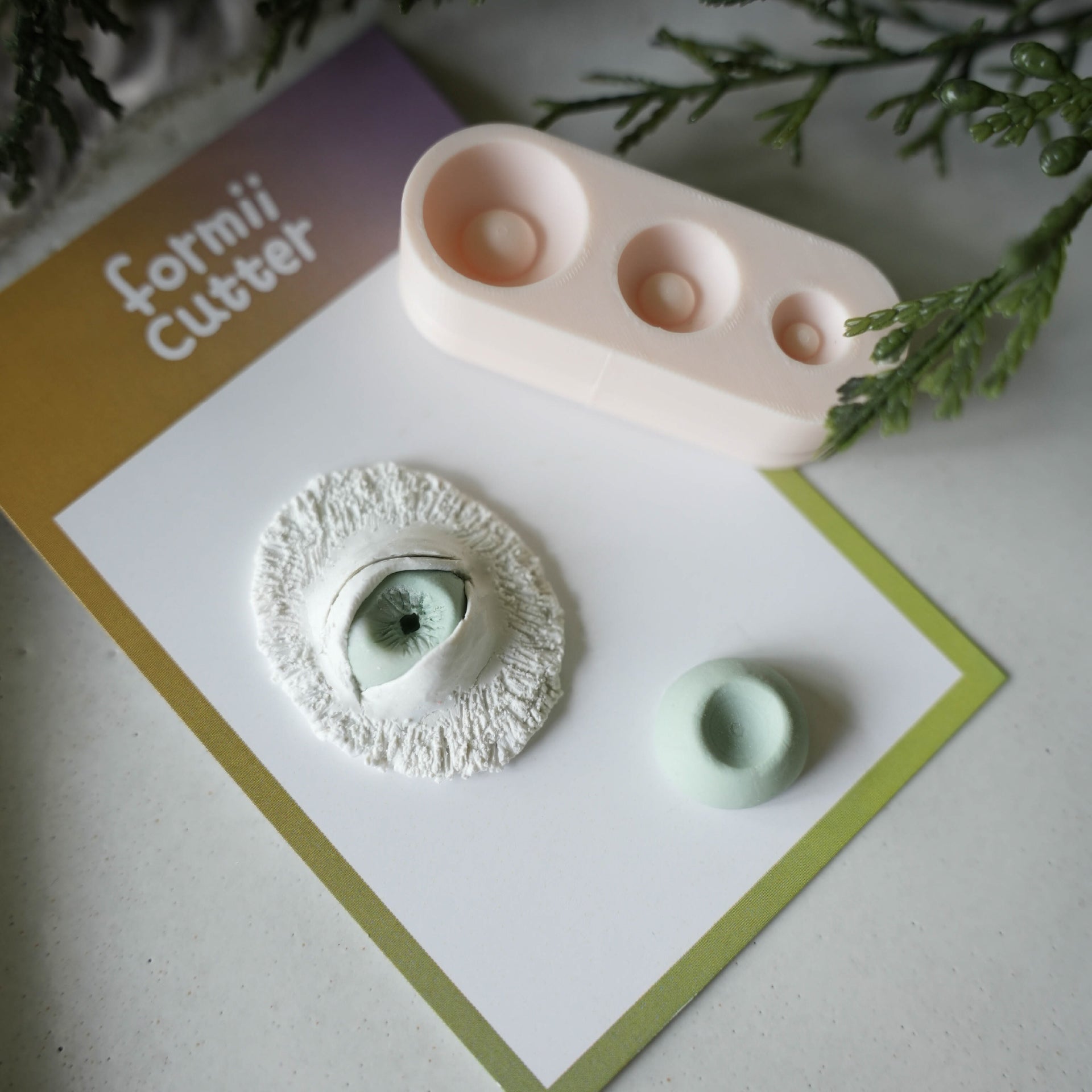 Polymer clay flower center forming tool shown with a clay floral project