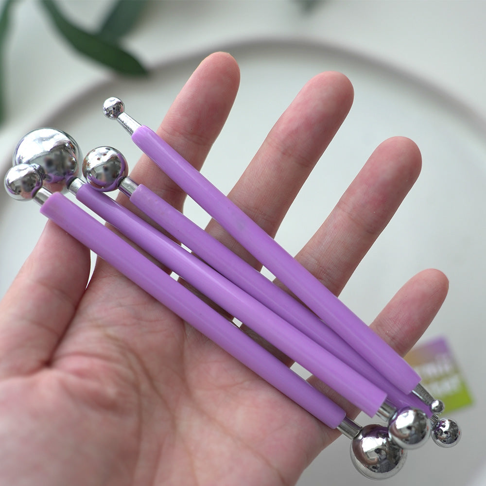Four purple-handled double-ended ball stylus tools