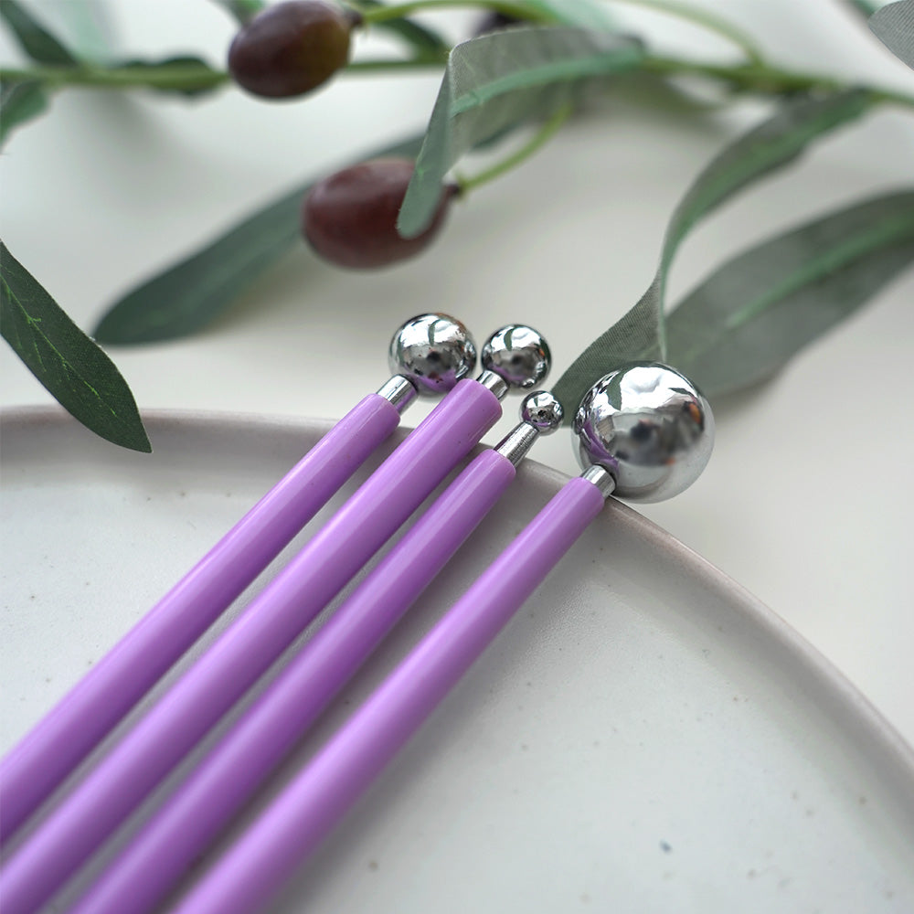 Four purple-handled double-ended ball stylus tools