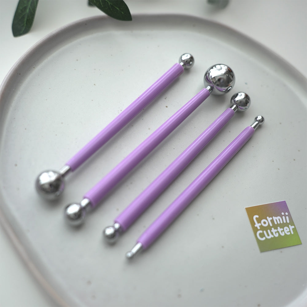 Four purple-handled double-ended ball stylus tools