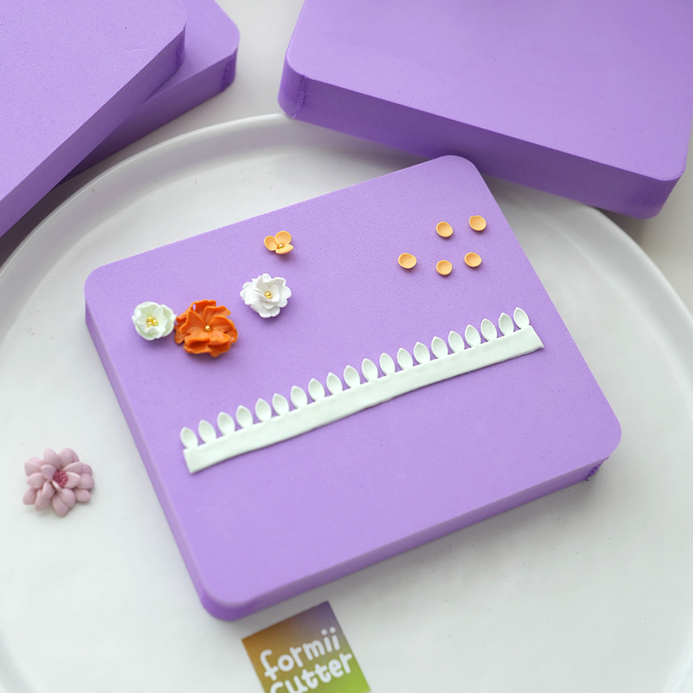 Purple flower shaping pad with demonstration props