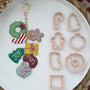 Seven FG101 Christmas cutter designs with finished clay examples