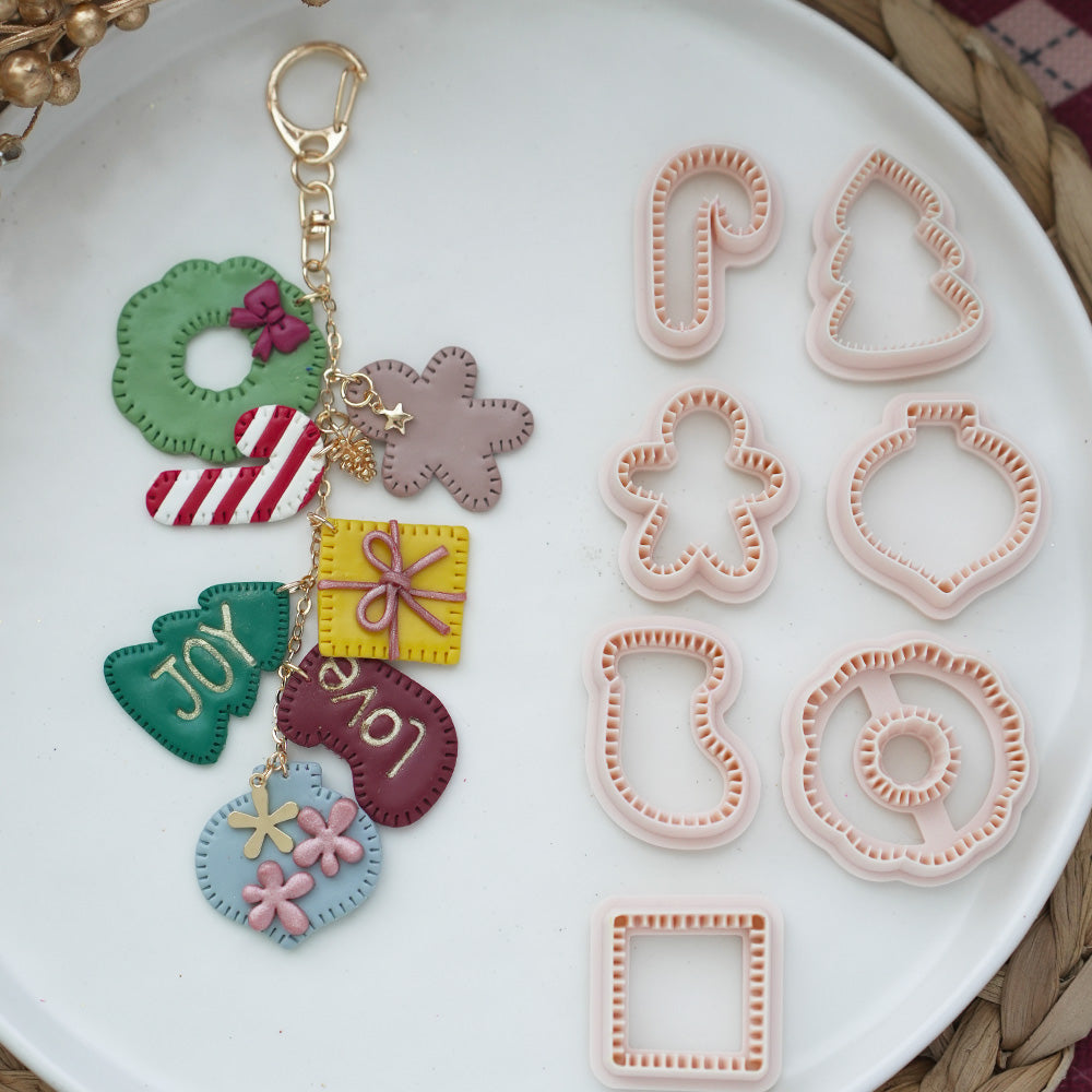 Seven FG101 Christmas cutter designs with finished clay examples